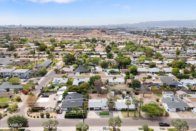 aerial view of residential area featuring mountains