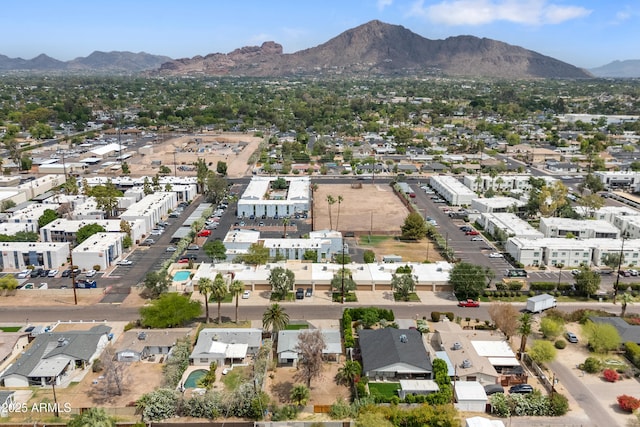 aerial view of property and surrounding area with mountains and nearby suburban area