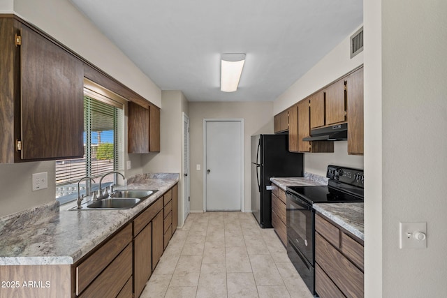 kitchen featuring under cabinet range hood, a sink, visible vents, light countertops, and black appliances