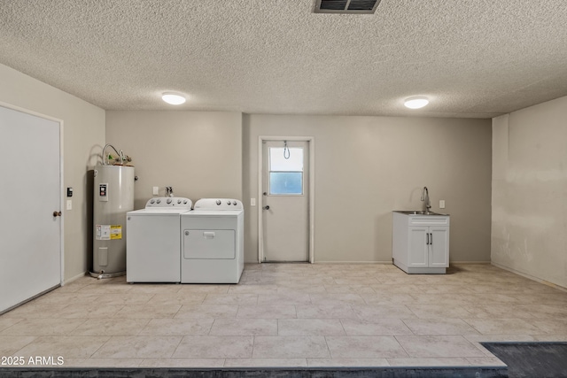 washroom with electric water heater, a sink, visible vents, independent washer and dryer, and cabinet space