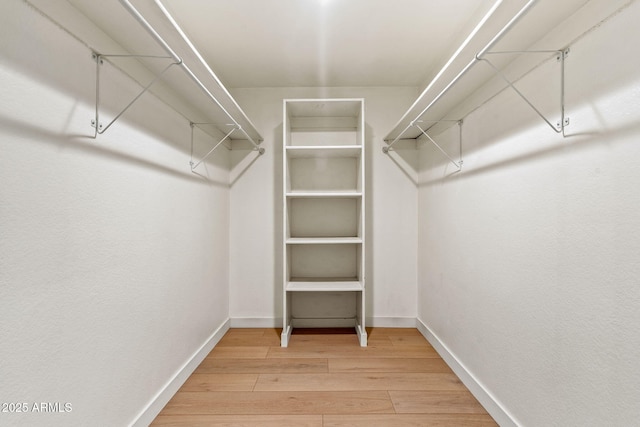 spacious closet with wood finished floors