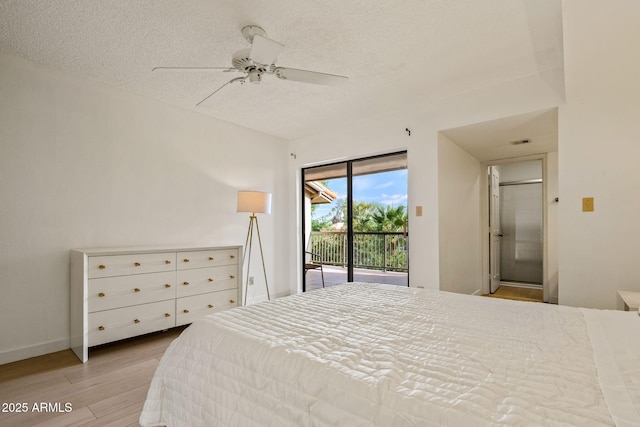 bedroom with a textured ceiling, wood finished floors, visible vents, baseboards, and access to outside