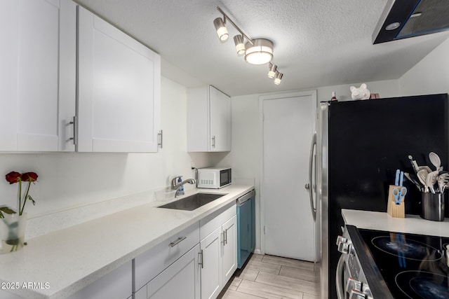 kitchen with stainless steel appliances, white cabinets, and a sink