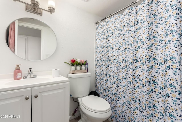 full bathroom featuring vanity, toilet, and a shower stall