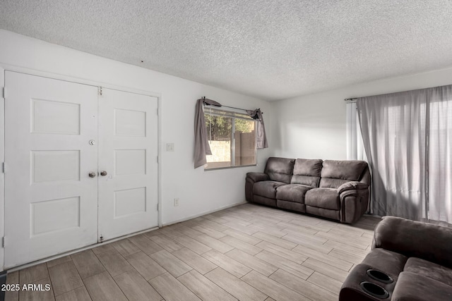 living room with a textured ceiling and wood finish floors