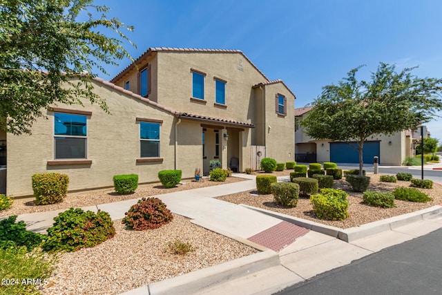 mediterranean / spanish home featuring stucco siding and a tile roof