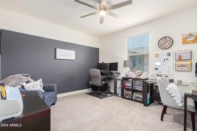 carpeted office featuring baseboards and a ceiling fan