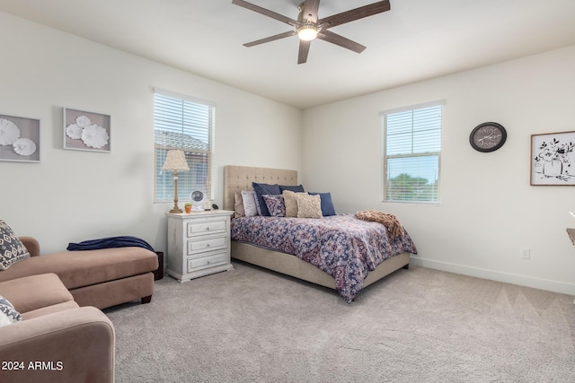 bedroom with carpet floors, multiple windows, and baseboards