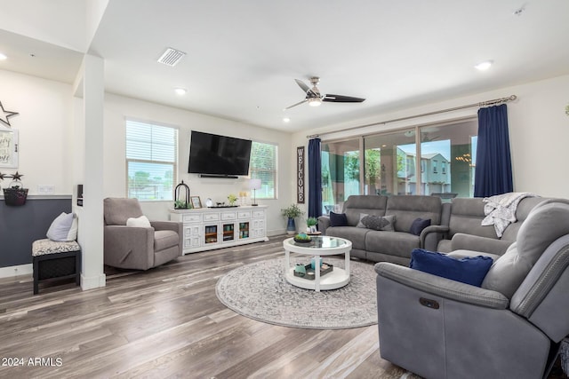 living room featuring recessed lighting, ceiling fan, visible vents, and wood finished floors
