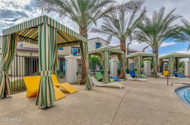 view of play area with fence, a patio, a gazebo, and an outdoor pool