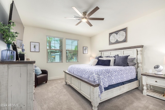 bedroom featuring baseboards, a ceiling fan, and light carpet