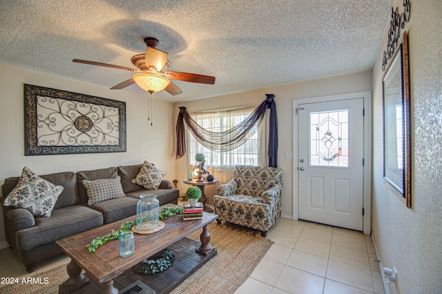 tiled living room featuring a textured ceiling and ceiling fan