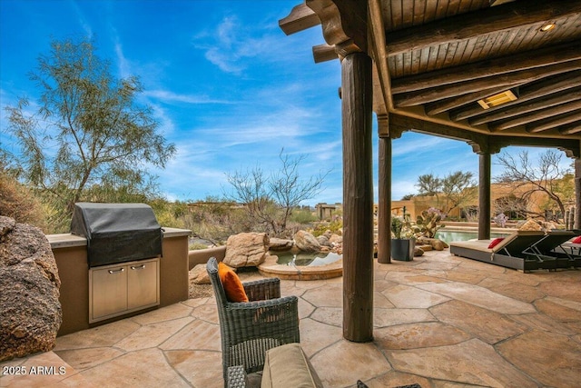 view of patio / terrace with exterior kitchen and a grill