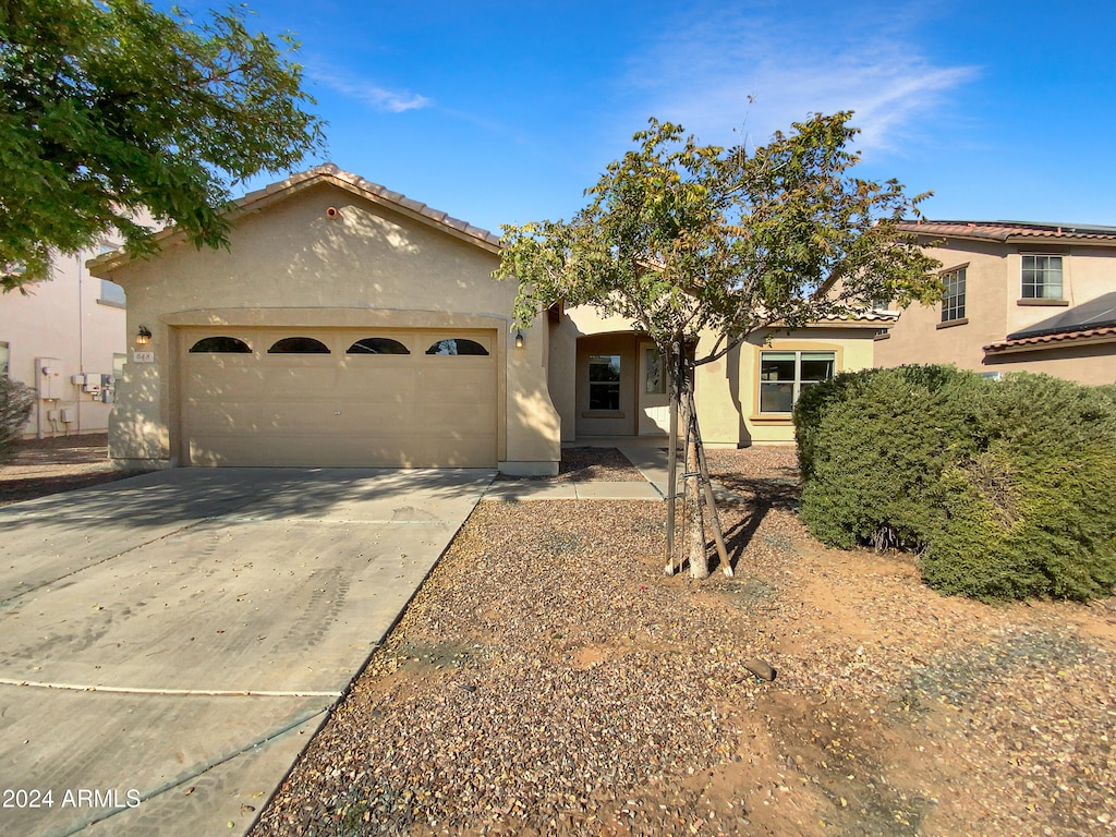 mediterranean / spanish-style home featuring a garage