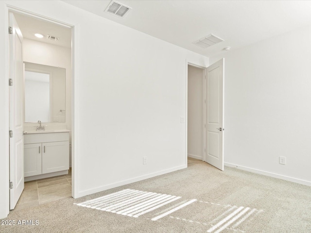 unfurnished room with light carpet and sink