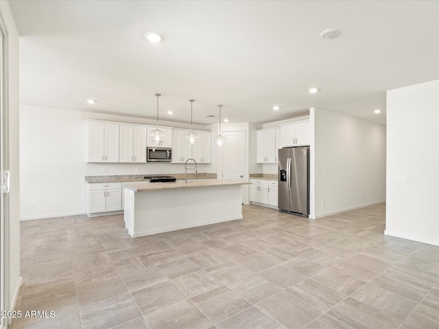 kitchen featuring sink, an island with sink, pendant lighting, white cabinets, and appliances with stainless steel finishes