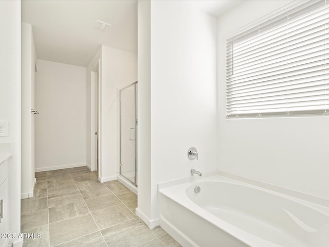 bathroom featuring vanity and shower with separate bathtub