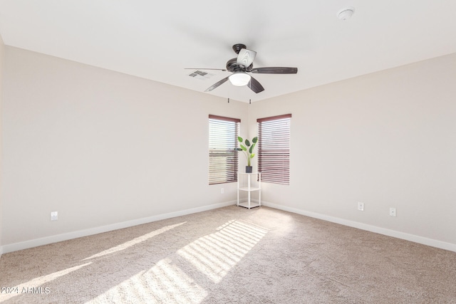 unfurnished room with ceiling fan and light colored carpet