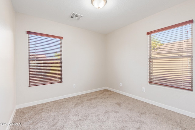 empty room featuring light carpet