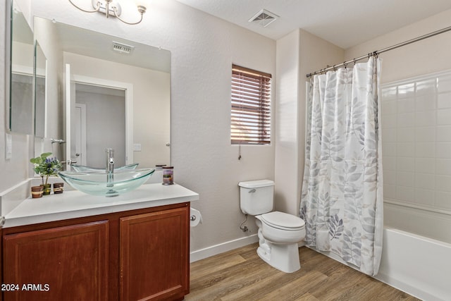 full bathroom featuring vanity, toilet, hardwood / wood-style flooring, and shower / bath combo