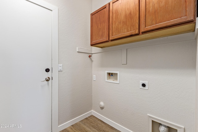 laundry area with cabinets, washer hookup, light wood-type flooring, electric dryer hookup, and hookup for a gas dryer