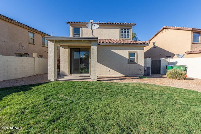 rear view of property with a patio area and a lawn