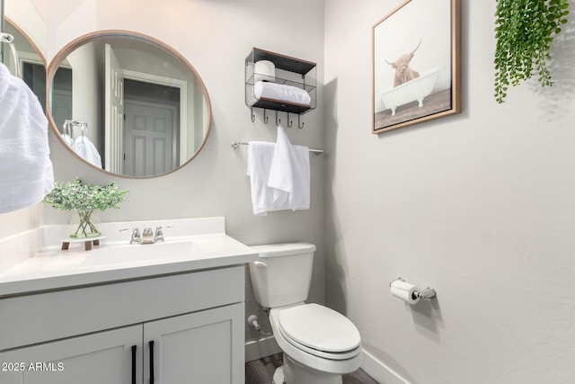 3938 E Appaloosa Rd, Gilbert, AZ 85296 - bathroom with toilet, vanity, baseboards, and wood finished floors