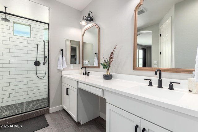 3938 E Appaloosa Rd, Gilbert, AZ 85296 - full bathroom featuring double vanity, healthy amount of natural light, tiled shower, and wood finished floors