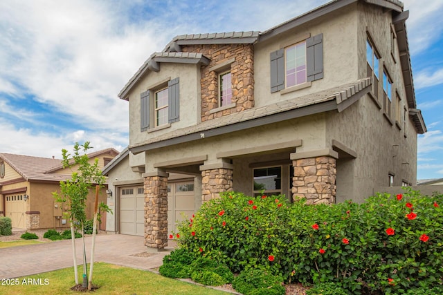 3938 E Appaloosa Rd, Gilbert, AZ 85296 - view of front of property featuring stone siding, stucco siding, an attached garage, and decorative driveway