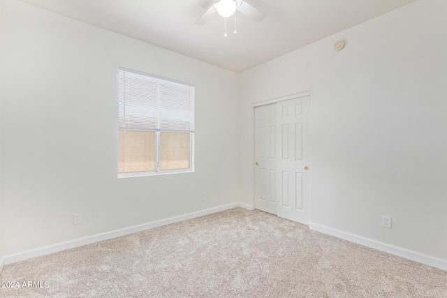 carpeted empty room with ceiling fan