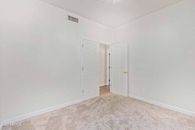 carpeted empty room with ceiling fan