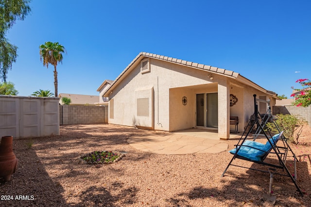 back of house with a patio area