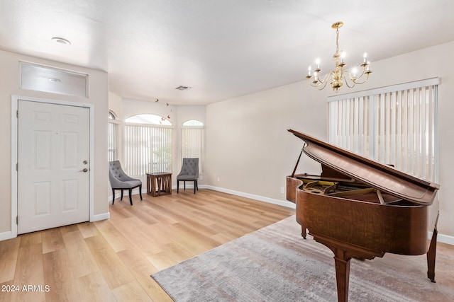 sitting room featuring light hardwood / wood-style flooring and a notable chandelier