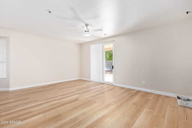 empty room featuring light hardwood / wood-style flooring and ceiling fan