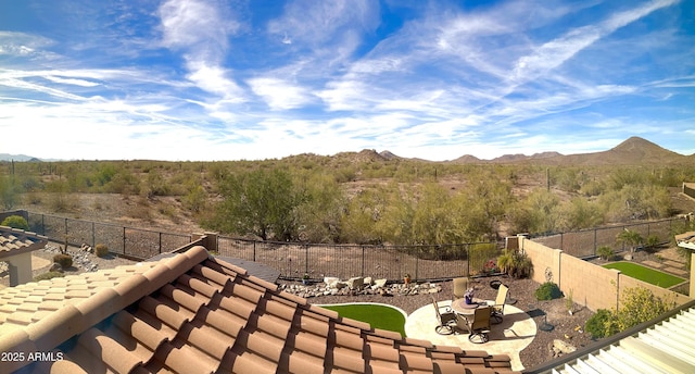 exterior space featuring a mountain view, fence, and a patio