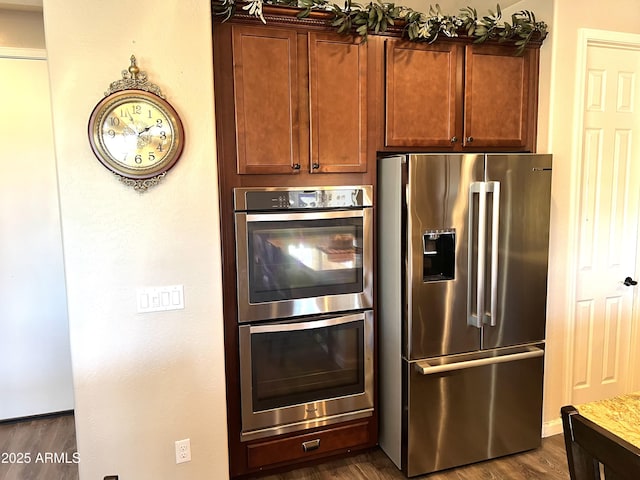 kitchen with stainless steel appliances and dark wood finished floors