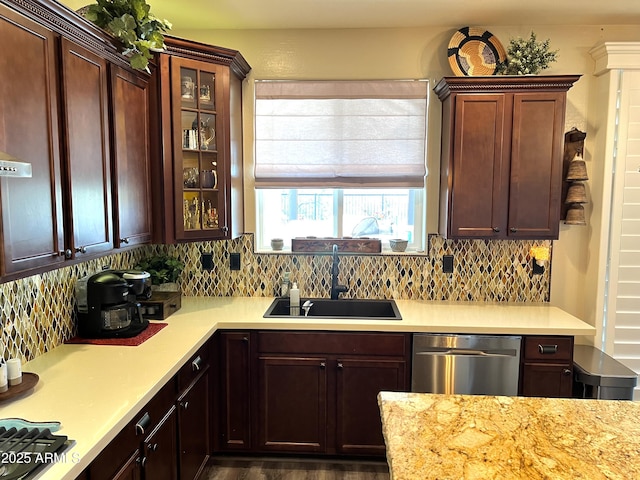 kitchen featuring stainless steel dishwasher, sink, and decorative backsplash