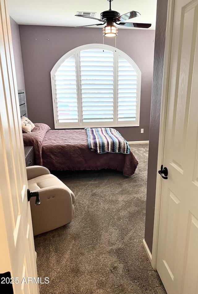 carpeted bedroom with ceiling fan, visible vents, and baseboards