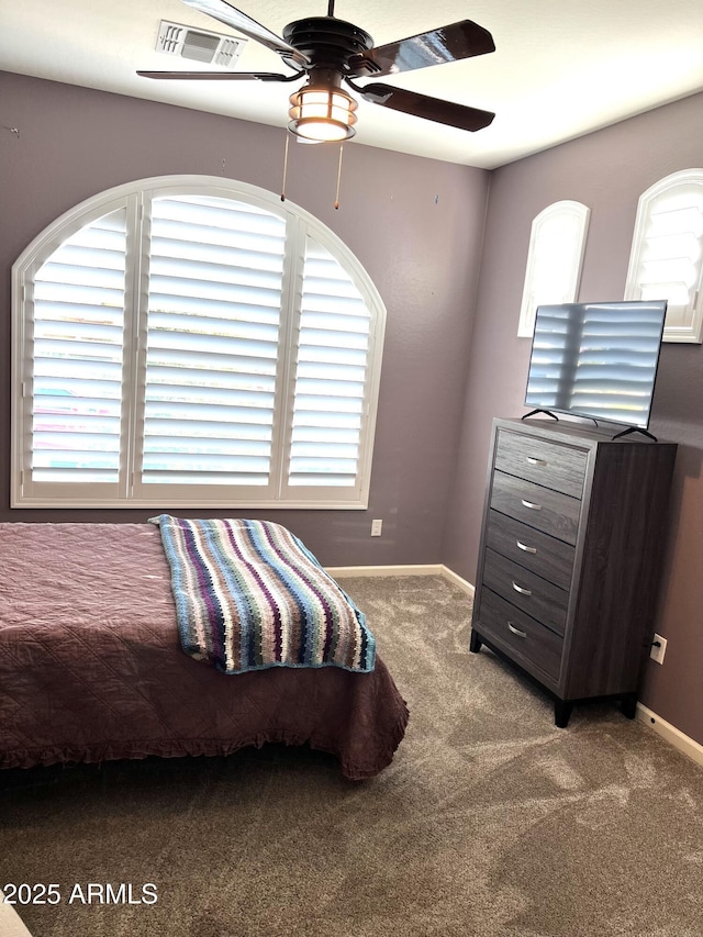 carpeted bedroom featuring visible vents, ceiling fan, and baseboards