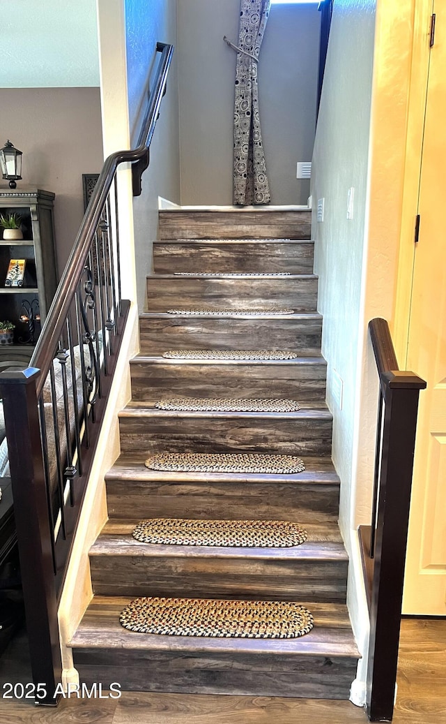 staircase with wood finished floors