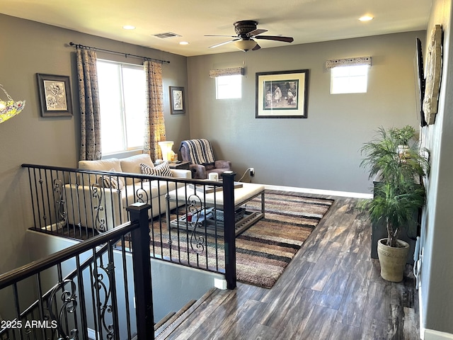 interior space with recessed lighting, wood finished floors, visible vents, a ceiling fan, and baseboards