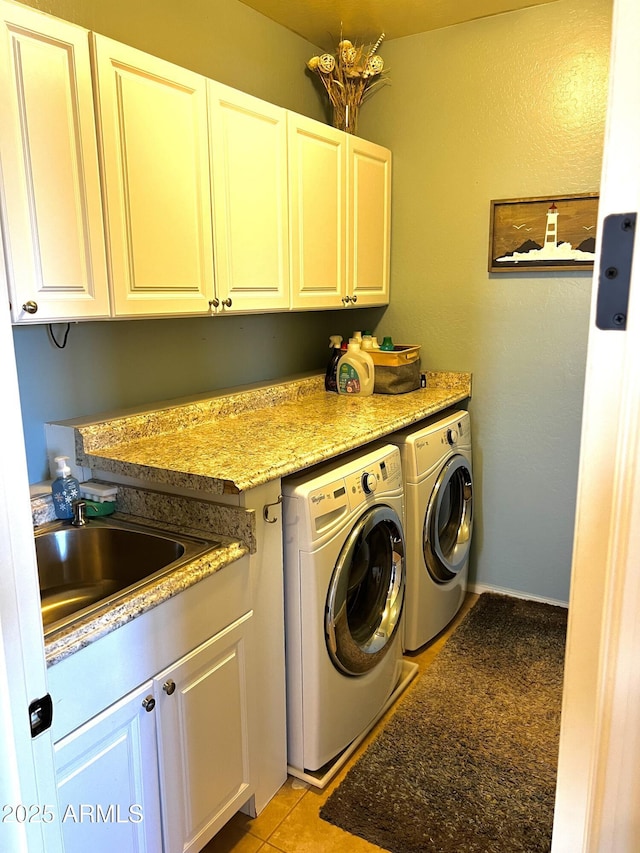 clothes washing area featuring washer and dryer, cabinet space, a sink, and light tile patterned floors