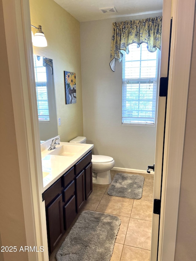 bathroom featuring vanity, tile patterned floors, and toilet