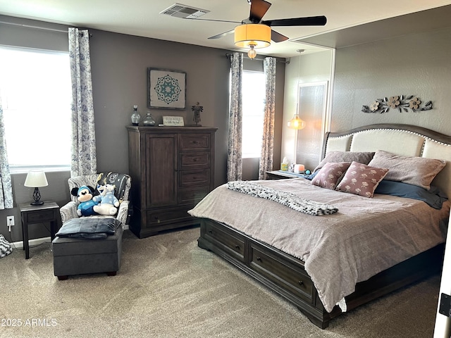 bedroom with light carpet, ceiling fan, and visible vents