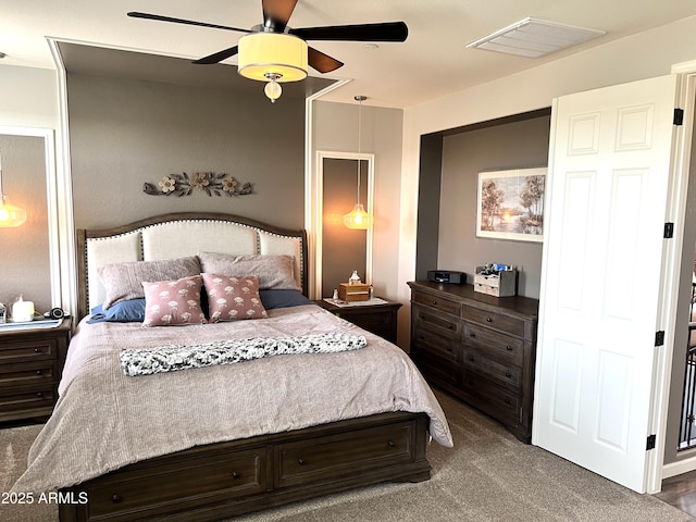 carpeted bedroom featuring visible vents and a ceiling fan