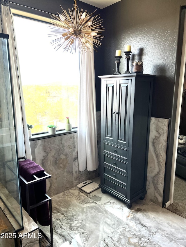 bathroom with a notable chandelier