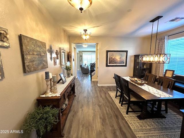 interior space with visible vents, dark wood finished floors, and baseboards