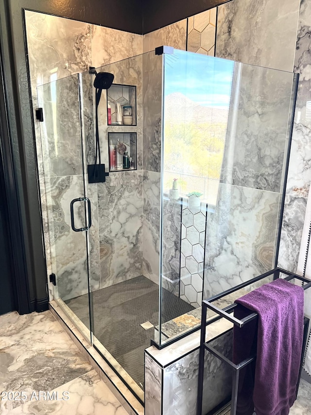 bathroom featuring a shower with door