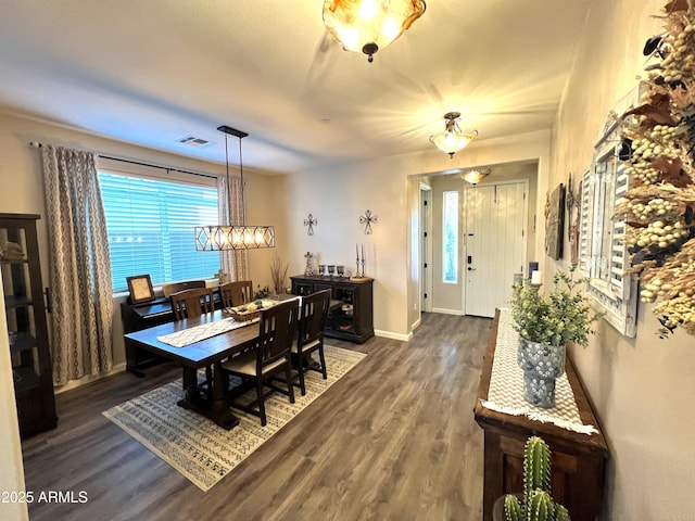 dining area featuring baseboards, visible vents, and dark wood-style flooring