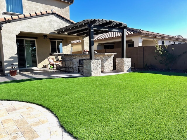 view of yard with outdoor dry bar, a patio, fence, and a pergola